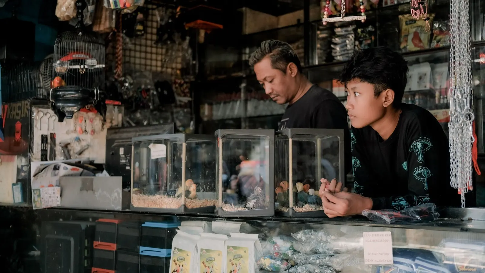 A pet shop counter with a customer being served.